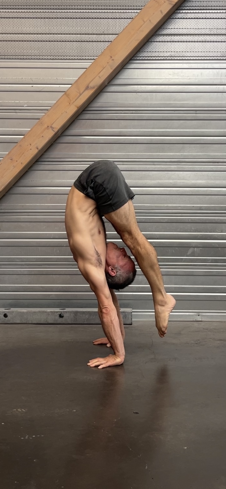 One-arm handstand by industrial shutter