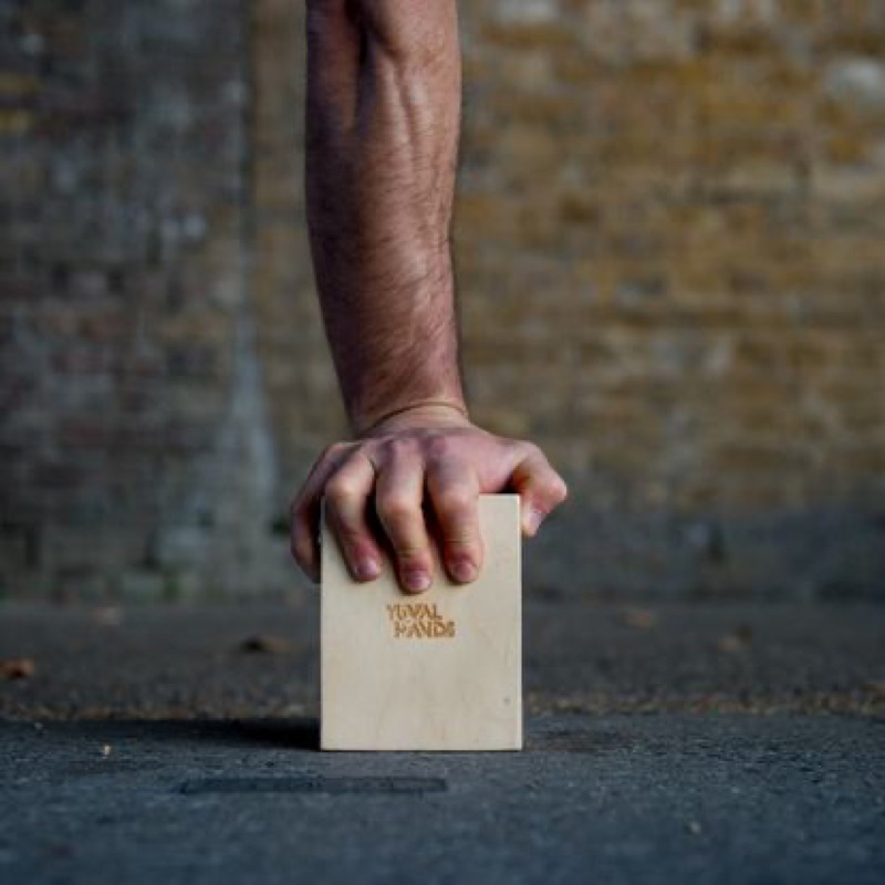Hand gripping the handstand cube